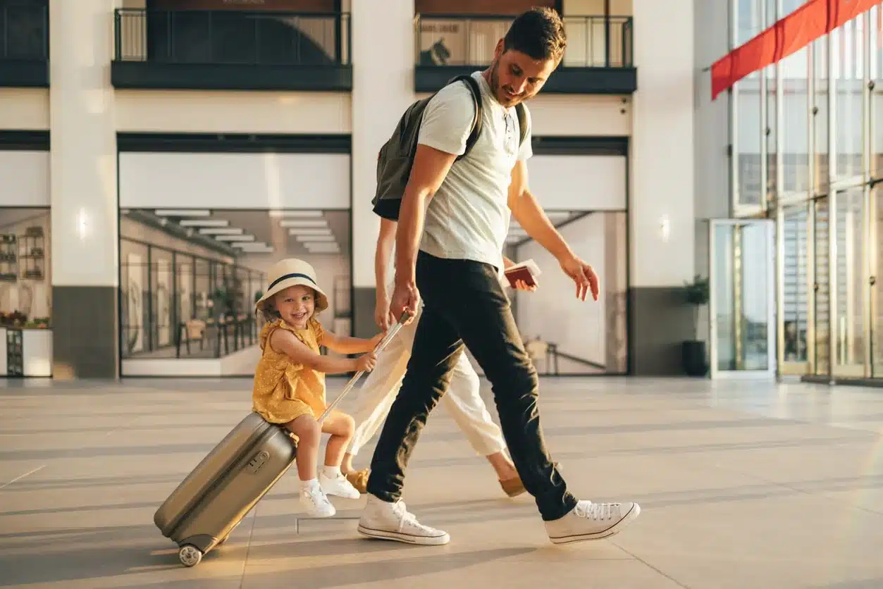 Father walking daughter through an airport